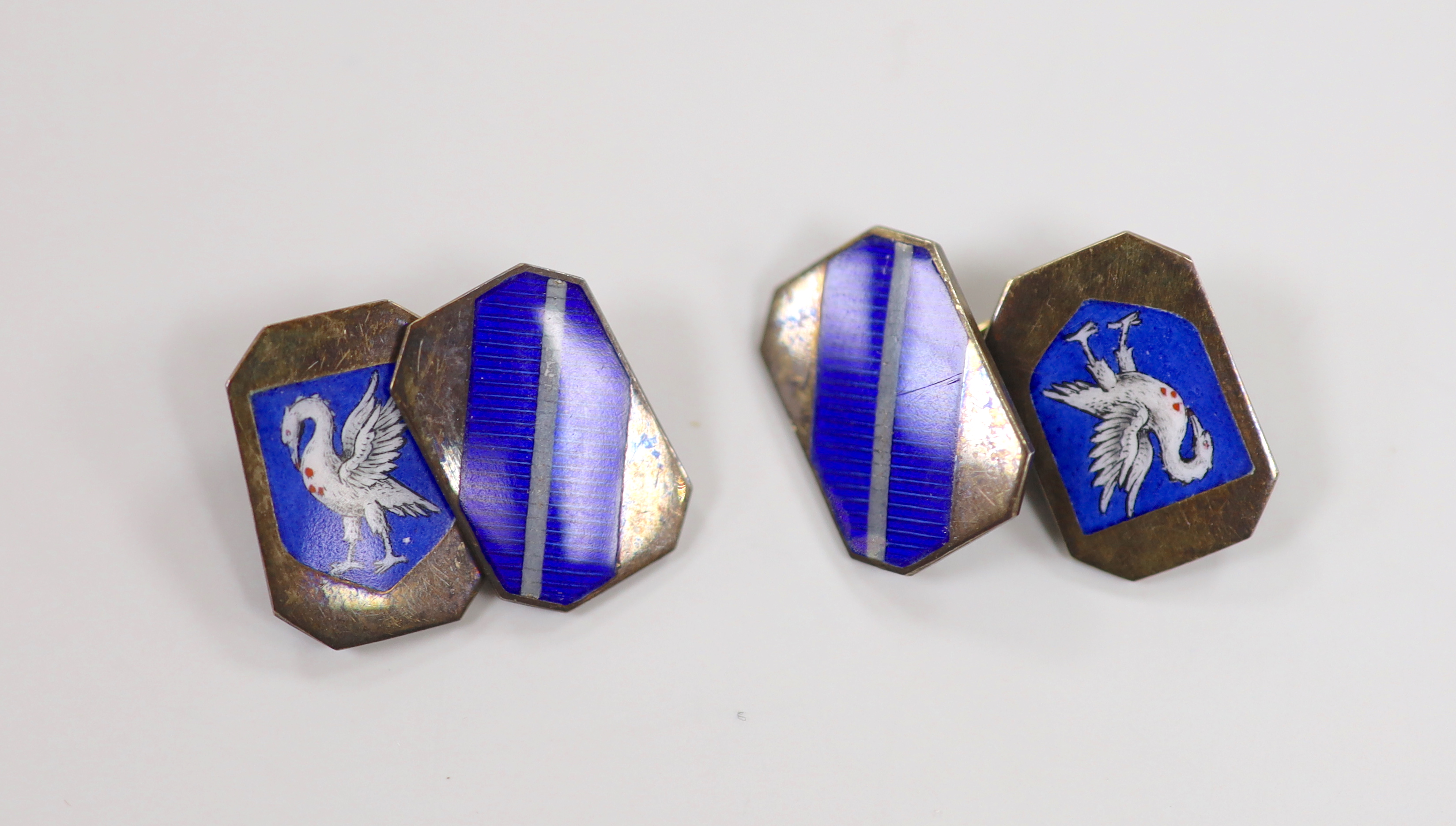 A cased pair of early 1950's 9ct gold and enamelled cufflinks with swan armorial, 17mm, gross weight 9.2 grams.